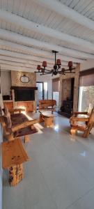 Habitación grande con bancos de madera y chimenea. en Casa Chapanay, en Corralitos