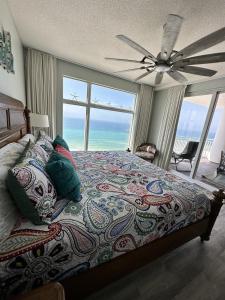 a bedroom with a bed with a view of the ocean at Sterling Reef 907 - Brent's Beach in Panama City Beach +45 photos