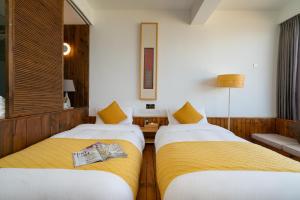 Postel nebo postele na pokoji v ubytování Manwu Dali Jimu Boutique Guesthouse