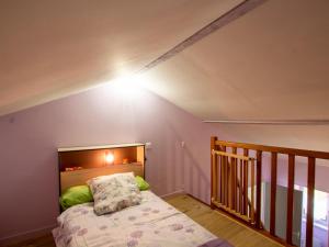 a bedroom with a bed with a light on the wall at Maison Périgord près de Sarlat, calme et charme - FR-1-616-16 in La Roque-Gageac
