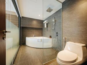 a bathroom with a toilet and a shower and a sink at Hi-Home Suites - Penstudio Westlake Hanoi in Hanoi +49 photos