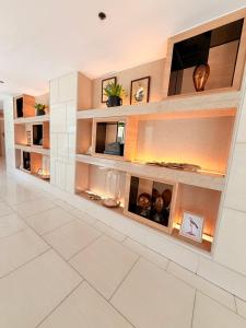 a living room with a large wall of shelves at Shell Residences Condotel by PauL in Manila