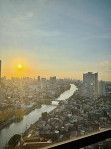 a view of a river in a city at sunset at Rockwell View King Suites in Manila