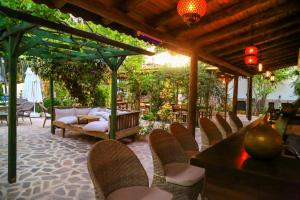 a group of chairs sitting under a pergola at Dardanos Hotel in Patara