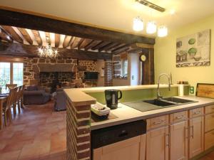 a kitchen with a sink and a living room at Maison écologique du XVe siècle avec jardin clos et garage, idéale pour une escapade paisible - FR-1-497-7 in La Baroche-sous-Lucé