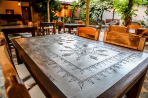 a wooden table with a design on top of it at Dardanos Hotel in Patara