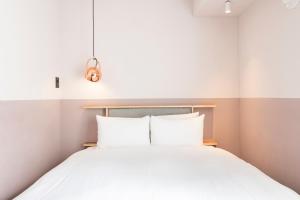 Postel nebo postele na pokoji v ubytování Hotel Asakusa KANNONURA