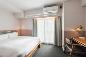 Postel nebo postele na pokoji v ubytování Hotel Asakusa KANNONURA