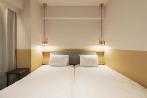 Postel nebo postele na pokoji v ubytování Hotel Asakusa KANNONURA