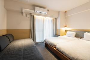 Postel nebo postele na pokoji v ubytování Hotel Asakusa KANNONURA