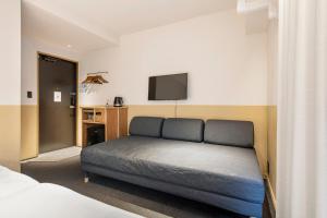 Postel nebo postele na pokoji v ubytování Hotel Asakusa KANNONURA