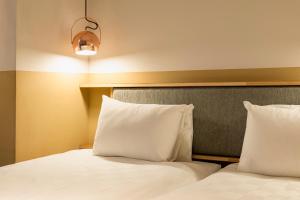 Postel nebo postele na pokoji v ubytování Hotel Asakusa KANNONURA
