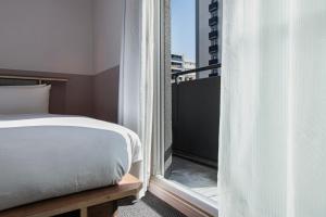 Postel nebo postele na pokoji v ubytování Hotel Asakusa KANNONURA