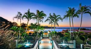 a view of a resort with palm trees and the ocean at Luxury Gold Coast Apartment with Rooftop Terrace in Gold Coast