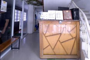 a wooden door with boxes on top of it at Jardin Oriental Suites Ubelt Manila in Manila