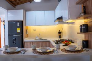 a kitchen with a counter with bowls and plates on it at Hospédate en Oiba con estilo in Oiba +27 photos