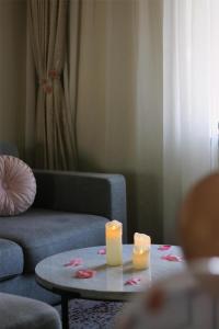 a living room with a couch and two candles on a table at Kempinski Hotel Beijing Yansha Center in Beijing