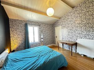 a bedroom with a blue bed and a desk at Spacieuse Maison 4 Chambres, Centre Fouras, Proche Plages - FR-1-709-96 in Fouras