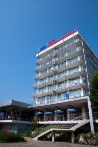 a hotel with a sign on top of it at Hotel Coop - Kiten in Kiten