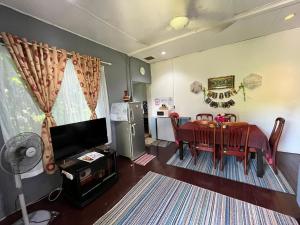 クチンにあるSri Kandis Cottage Stayのリビングルーム(テーブル付)、ダイニングルーム