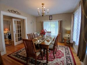 a dining room with a wooden table and chairs at Velocity Residence in Worcester