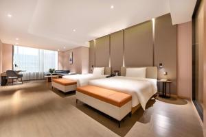 a hotel room with two beds and a desk at Atour Hotel Beijing Yizhuang New Town Majuqiao in Daxing +43 photos