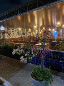 a restaurant with a bunch of flowers in front of it at Pousada dos Artistas in Campina Grande
