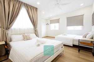 Ένα ή περισσότερα κρεβάτια σε δωμάτιο στο Jomstay MUJI 19 & 7 INN Ipoh Garden 8-10 pax