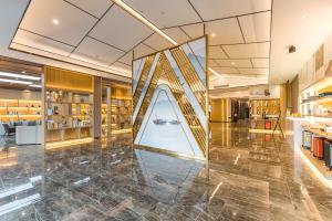 a lobby with a large glass wall in a building at Atour Hotel Suzhou Wangting in Suzhou +65 photos