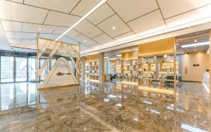 a library with a slide in the middle of a building at Atour Hotel Suzhou Wangting in Suzhou