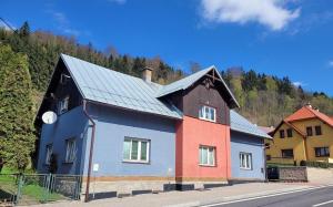 a colorful house on the side of a road at U Piškota in Desná
