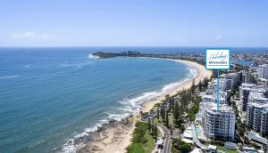 a view of a beach with a sign at Oceans Apt 203- 5-Star Luxury Beachfront Escape in Mooloolaba