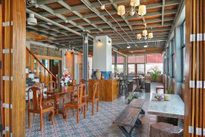 a dining room with a table and some chairs at Saeng Panya Home SHA Plus in Chiang Mai