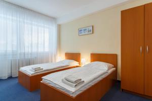 Postel nebo postele na pokoji v ubytování Hotel Veronika