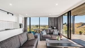 a living room with a couch and a table at The Black Cottage in Napier