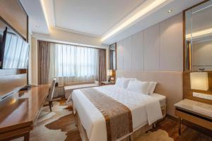 a hotel room with a bed and a television at Jinan Blue Horizon Hotel Shizhong in Jinan +167 photos