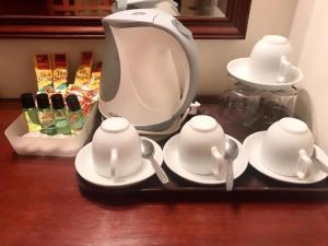 a tea set on a tray next to a mixer at South East Asia Hotel in Singapore