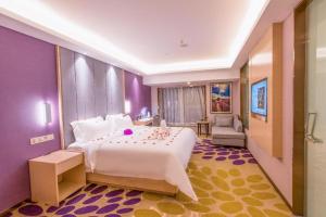 a bedroom with a large white bed and a purple wall at Lavande Hotels·Wuhan Zhuyeshan Metro Station in Wuhan