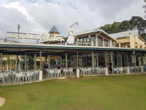 a building with tables and chairs in front of it at Aru corner 6B1BR Tanjung aru town kota kinabalu in Kota Kinabalu