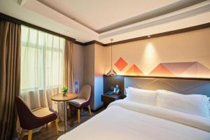 a hotel room with a bed and a table at Borrman Hotel Zhongshan Henglan Xiyong in Changzhou +243 photos
