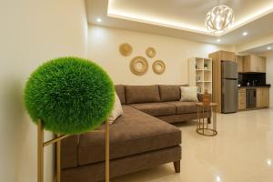 a living room with a couch and a large green plant at Central Park House - 70m² in Mohammedia