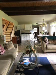 a living room with a couch and a table at Grandma's House - Large Home - DISCOUNT ON TOURS! in Mendenhaven