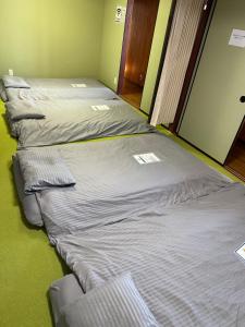 Postel nebo postele na pokoji v ubytování 一棟貸切温泉旅館house kuu