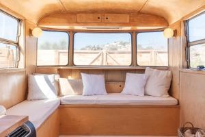 a seat in the back of a boat with pillows at Cozy Retreat Amidst Boulders in Yucca Valley