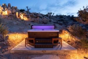 a hot tub in the middle of the desert at Cozy Retreat Amidst Boulders in Yucca Valley