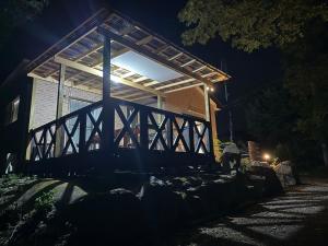 a wooden bridge in front of a building at night at コテージオギー in Nasu +23 photos