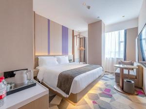 Giường trong phòng chung tại Lavande Hotel Zhongshan Shiqi Daxinxinduhui North Zhongshan Station +268 ảnh