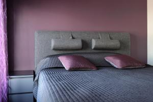 a bedroom with a bed with two pillows on it at Aida 7 Apartement in Pärnu