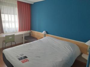 Ein Bett oder Betten in einem Zimmer der Unterkunft Ibis Ulm City