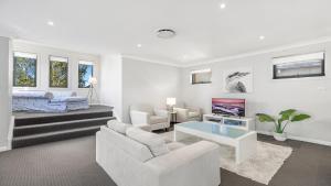 En eller flere senge i et værelse på Hunter Valley Lodge